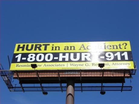lawyer advertising vanity phone number 1-800-HURT-911 on a Billboard