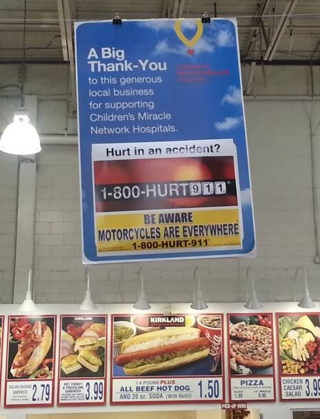 Billboard at Costco advertising motorcycle awareness and motorcycle lawyers