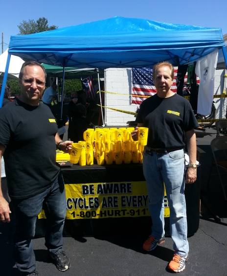 1-800-HURT-911® Tent with motorcycle lawyers handing out beer steins advertising motorcycle lawyers 