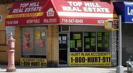 Personal injury lawyer sign advertising 1-800-HURT-911 on store front