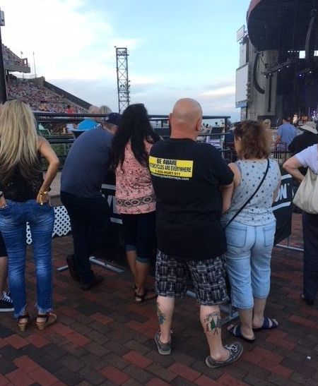 T-shirt with lawyer advertising for motorcycle accidents seen at a Chicago concert