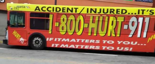 1-800-HURT-911 bus wrap with lawyer advertising
